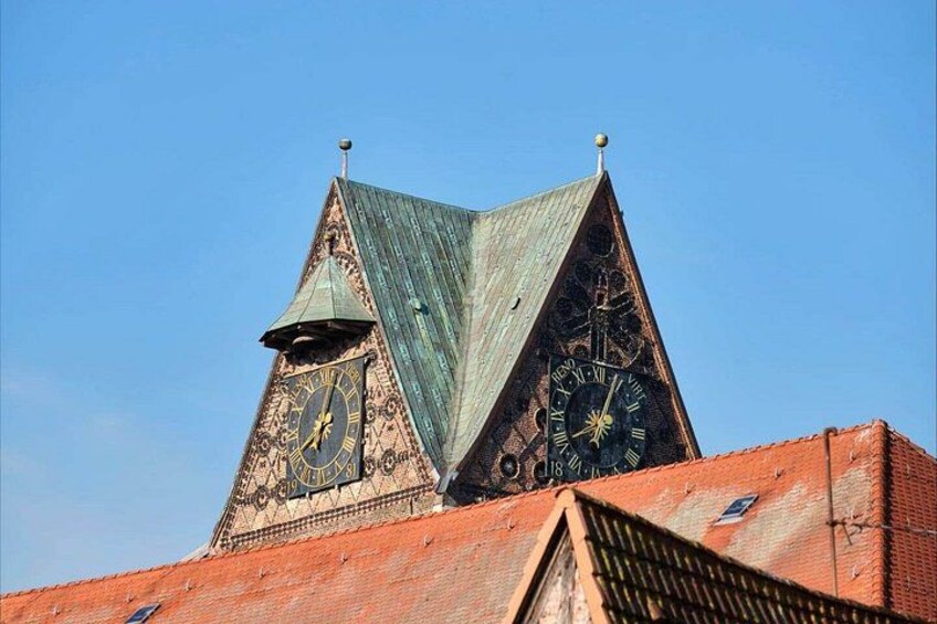 A building with a clock tower and a triangular roof. 3