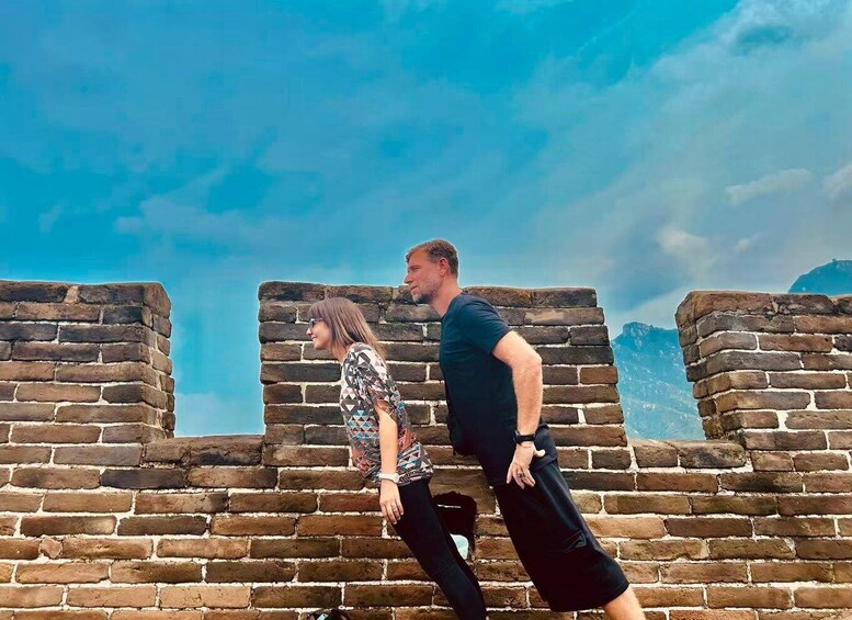 Two people walking along the Great Wall of China. 2