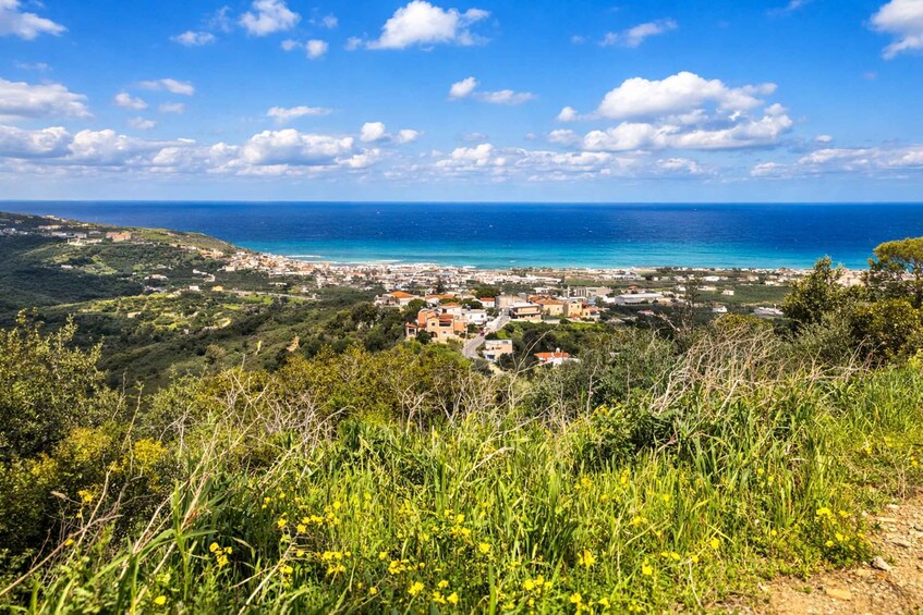 A coastal town with a clear view of the sea and a hilly landscape in the foreground. 3