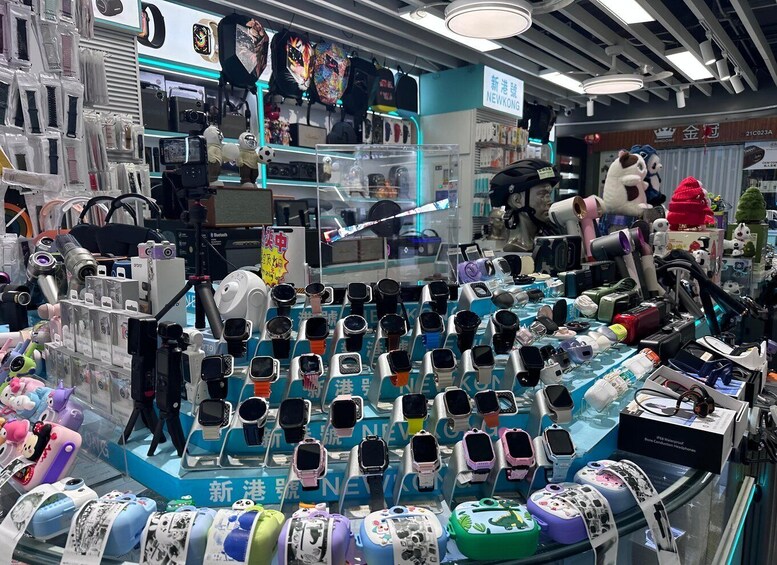 A store with various electronic devices on display, including watches and headphones. 2