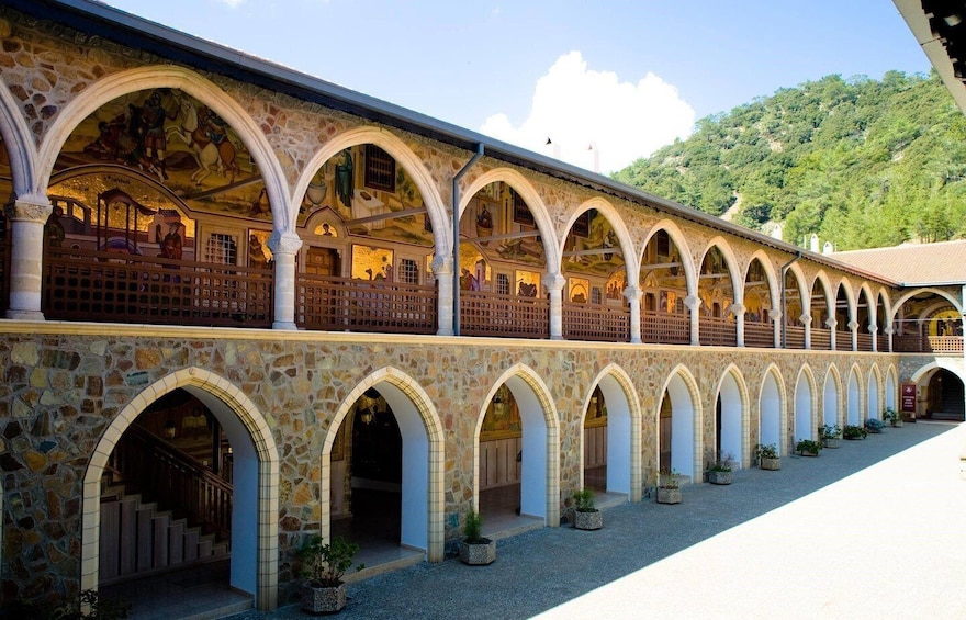 A stone building with multiple arches and a courtyard. 3