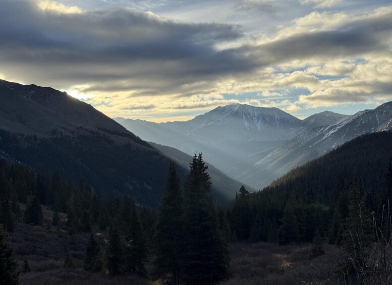 A mountainous landscape with dense forests and a valley. 2