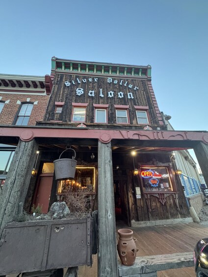A historic building with a sign reading 'Silver Dollar Saloon.' 4