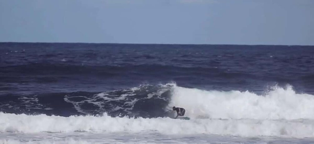 A surfer riding a wave in the ocean. 1