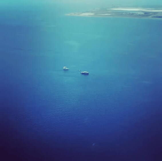 A vast ocean with two boats floating. 2