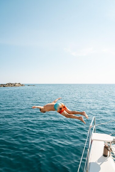 A person diving into the ocean from a boat. 5