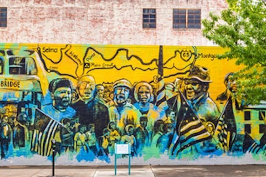 A mural with people and a bridge. 2