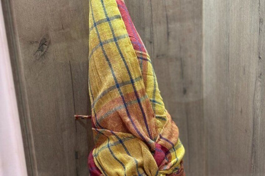 A plaid fabric hanging on a wooden surface. 4