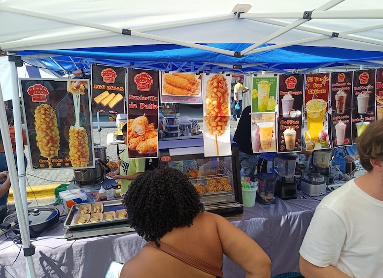 A food stall with various items like corn dogs, egg rolls, and coffee frappes. 3