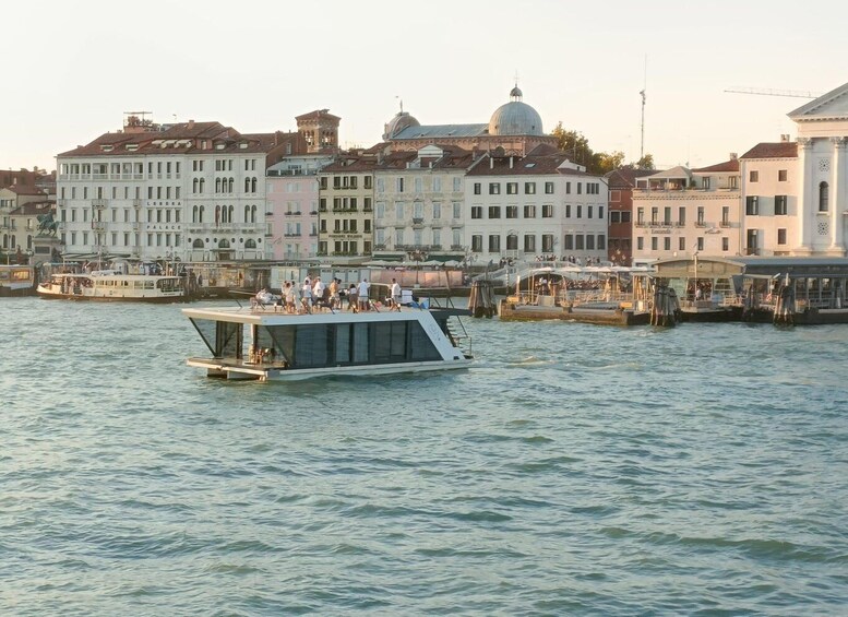 A riverboat with passengers, a cityscape with historic buildings, and a dome structure in the background. 5