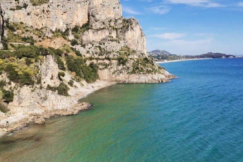 A coastal cliff with clear turquoise water. 5