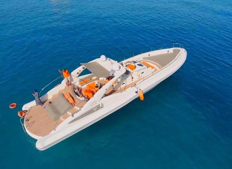 A white motorboat with orange life jackets and a person standing at the stern. 5