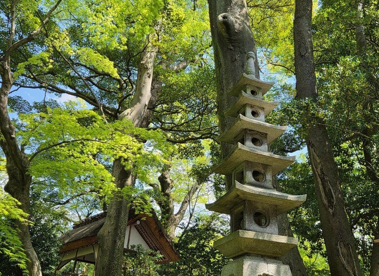 A traditional Japanese pagoda with multiple tiers, surrounded by lush green trees. 3