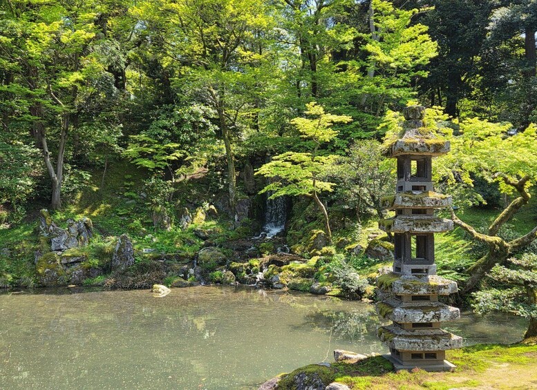 A traditional Japanese pagoda by a tranquil pond surrounded by lush greenery. 4