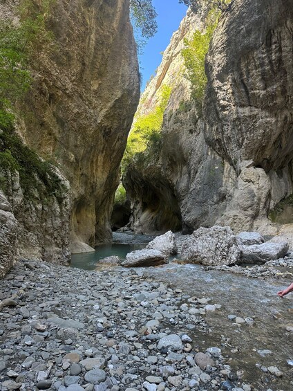 A rocky canyon with a narrow stream. 4