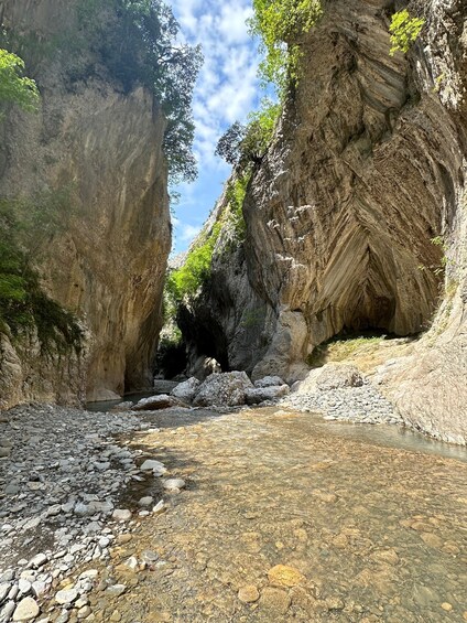 A rocky canyon with a clear stream flowing through it. 3