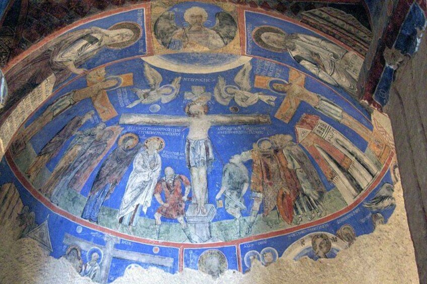 A circular mosaic with religious figures and symbols. 5