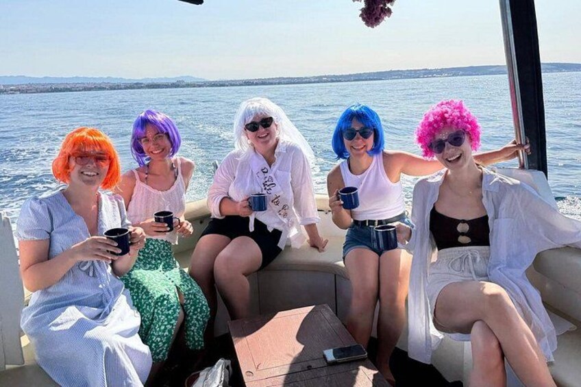 Un grupo de personas en un bote, con una masa de agua al fondo. 4