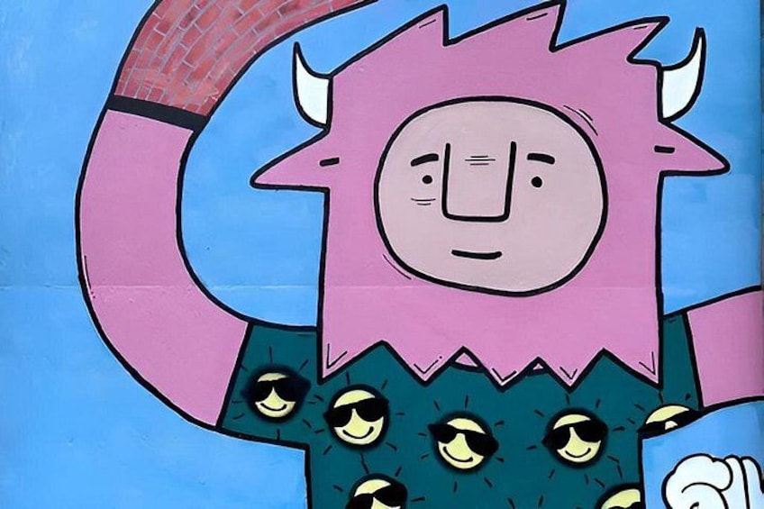 A cartoon character with a pink head and horns, a blue background, and a green outfit with yellow eyes. 3
