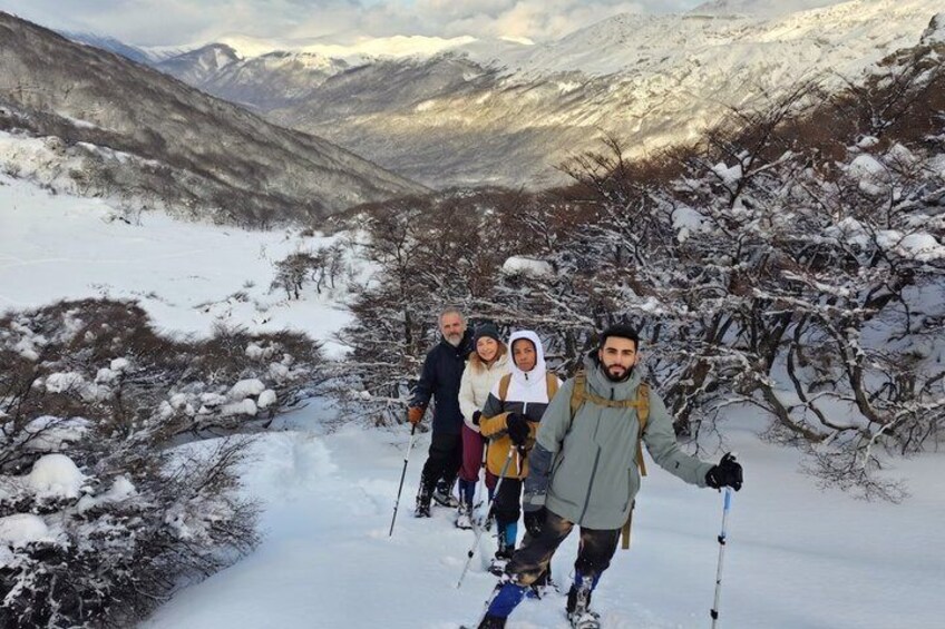 A group of people skiing on a snow-covered mountain path. 5