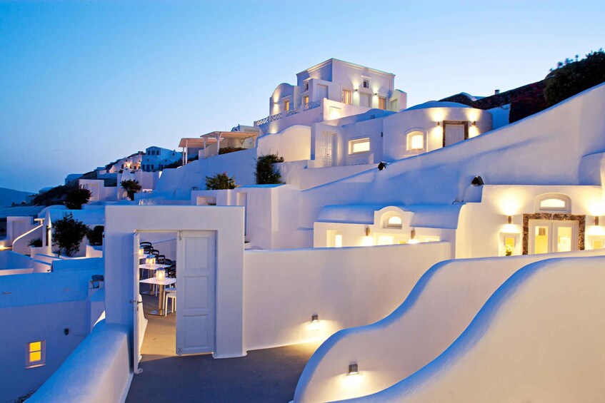 A coastal village with white-washed buildings and terraced streets. 3