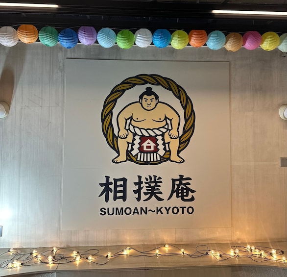 A sumo wrestler logo with Japanese text and a sumo ring. 3