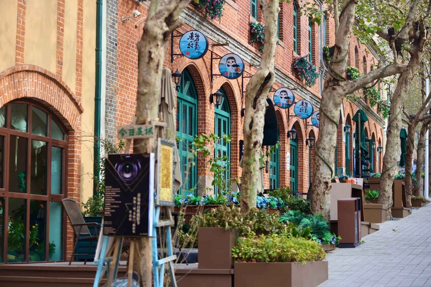 A brick building with arched windows and hanging signs. 5