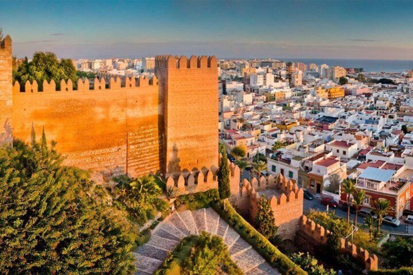 A historic city with a prominent fortification and a dense urban area. 1