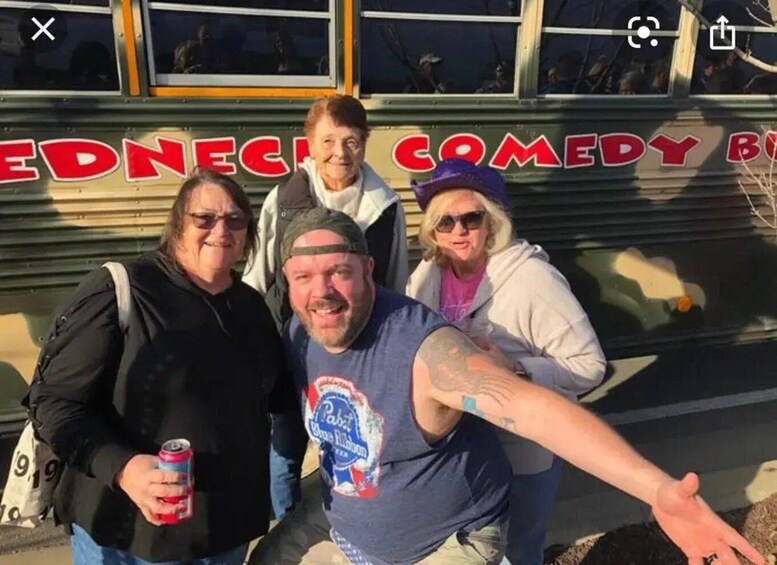 A group of people posing in front of a comedy bus. 1