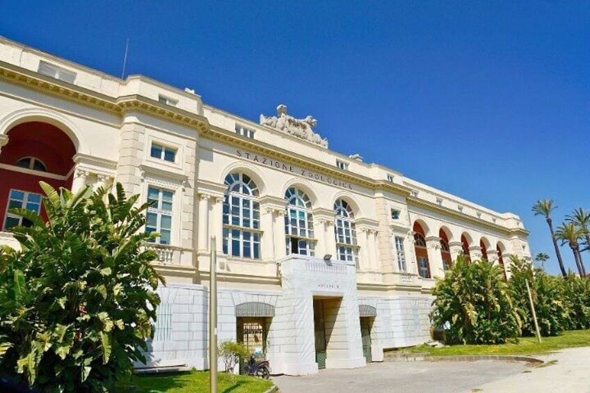 A large, classical building with arched windows and a prominent entrance. 4