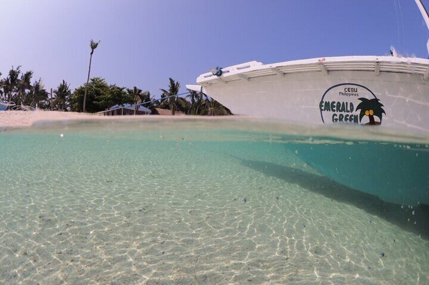 A boat named 'Emerald Green' with a logo of a palm tree and the text 'Cebu Philippines' on its side. 3