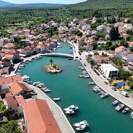 A coastal town with a marina, houses, and a bridge. 1