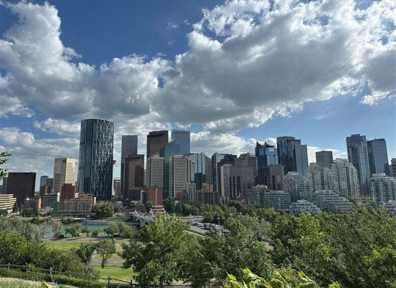 A city skyline with modern buildings and a park in the foreground. 4