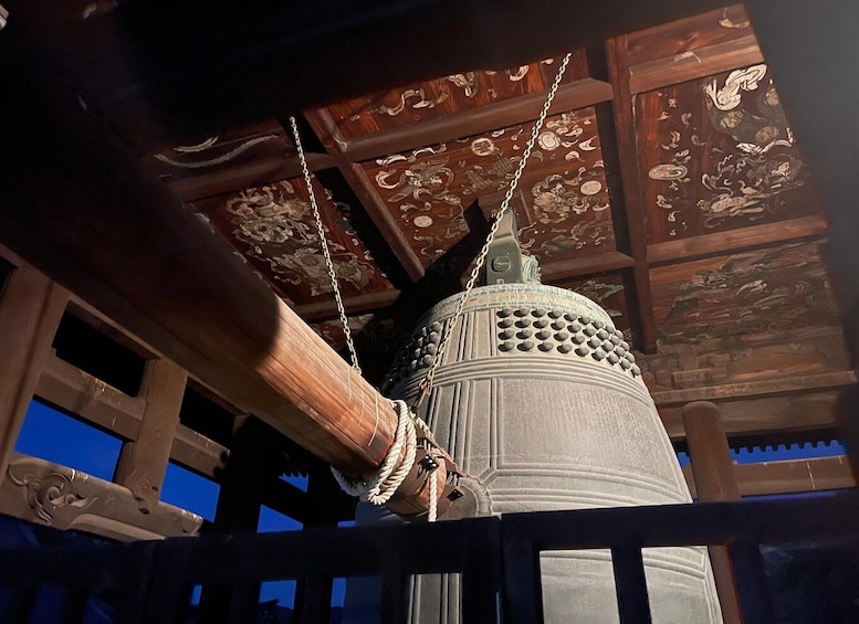 A traditional lantern with intricate carvings, suspended by a rope from a wooden structure. 3