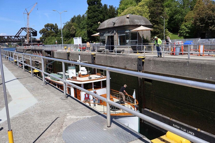 A lock system with boats, a bridge, and workers. 2
