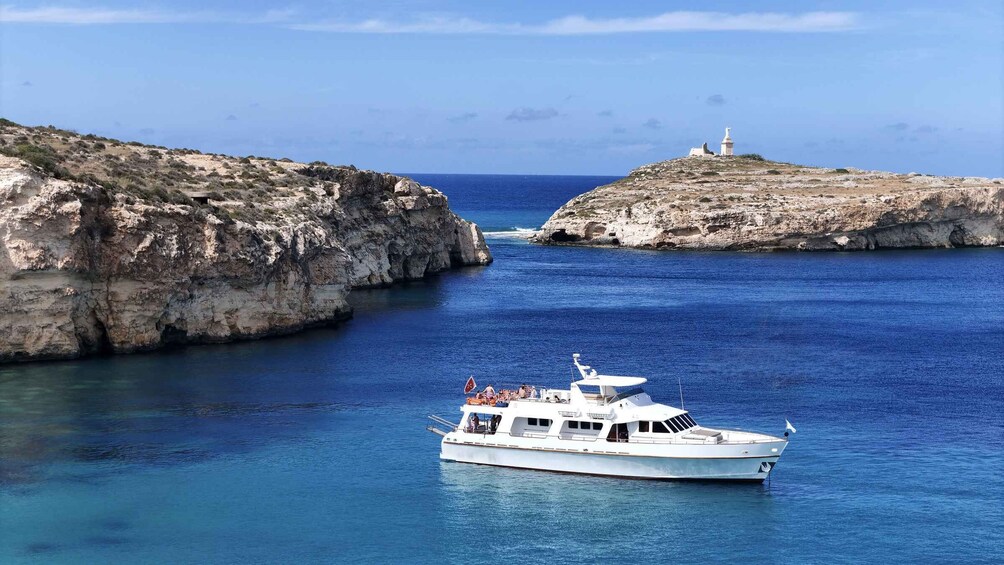 A boat navigating a narrow waterway between rocky cliffs. 1
