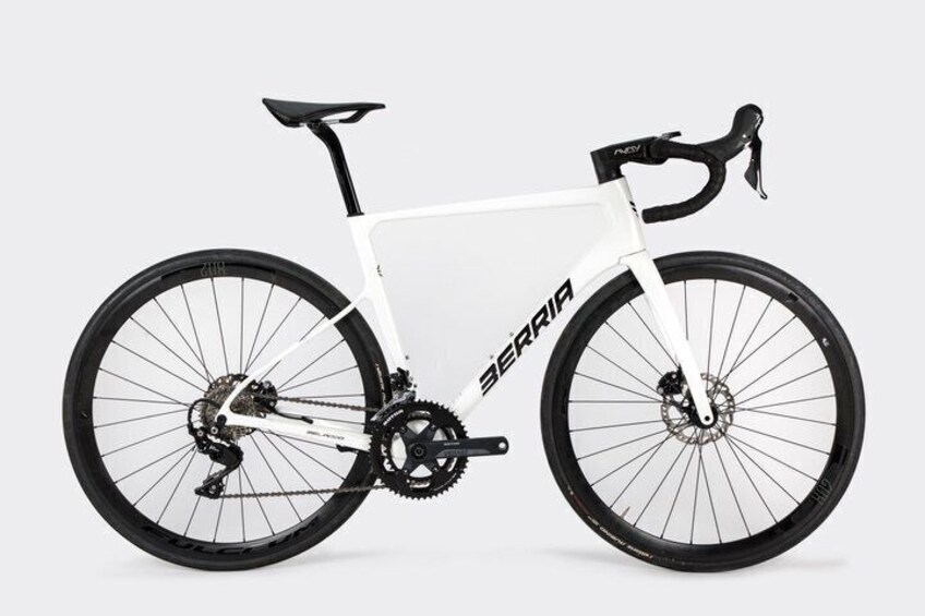 A white mountain bike with black components and the brand name 'SERRIA' on the frame. 3