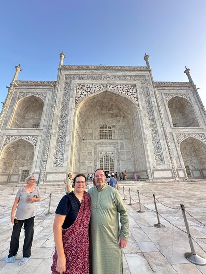 A couple standing in front of the Taj Mahal. 3