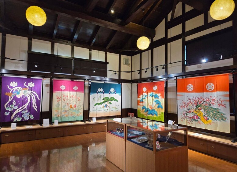 A traditional Japanese room with tatami flooring, shoji screens, and hanging paper lanterns. 1
