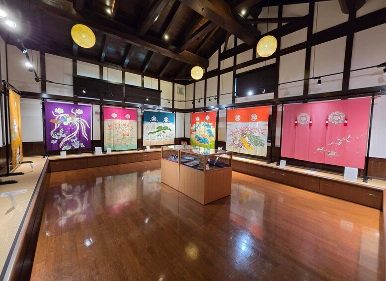 A traditional Japanese art exhibition with wooden display cases and hanging scrolls. 4