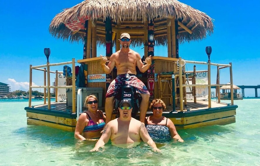 A wooden boat with a thatched roof, people on it, and clear turquoise water. 4