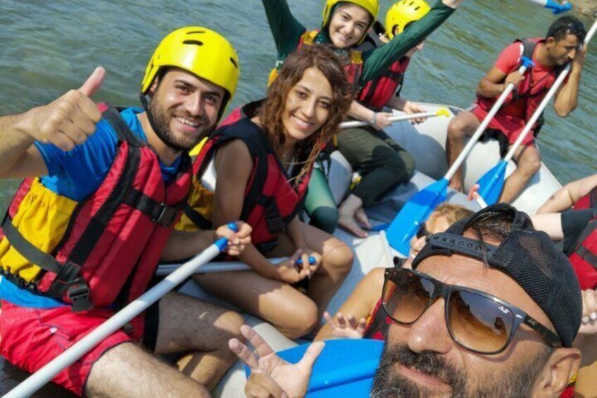 People in a boat wearing life jackets and helmets. 2