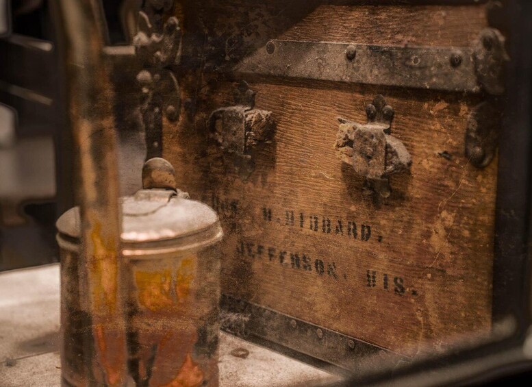 A wooden chest with metal clasps and a metal container with a lid. 4