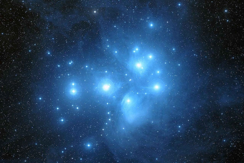 A starry night sky with a dense cluster of stars and a bright nebula. 3