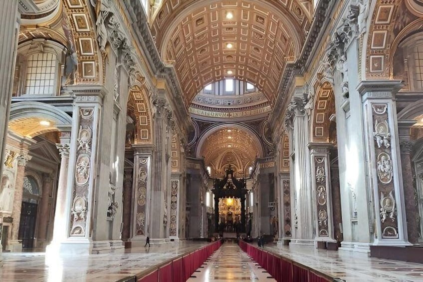 An ornate hall with a high ceiling, marble columns, and a central aisle. 3