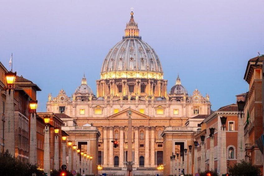 A grand historical building with a large dome, classical architecture, and a street with old buildings. 1