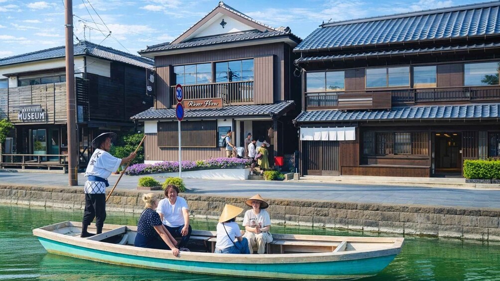 A river with a boat carrying people, a museum, and a building with a sign 'River Flow.' 5