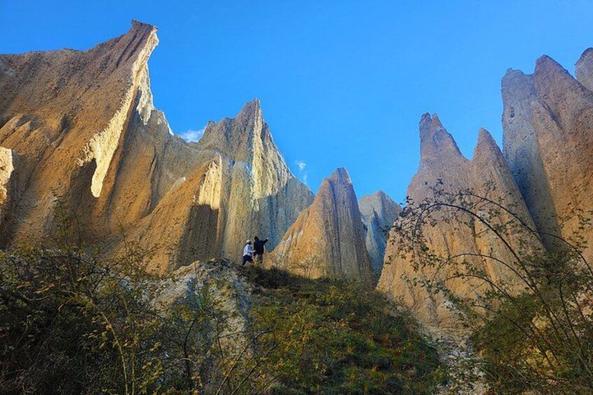 A mountainous landscape with sharp peaks and a clear sky. 2