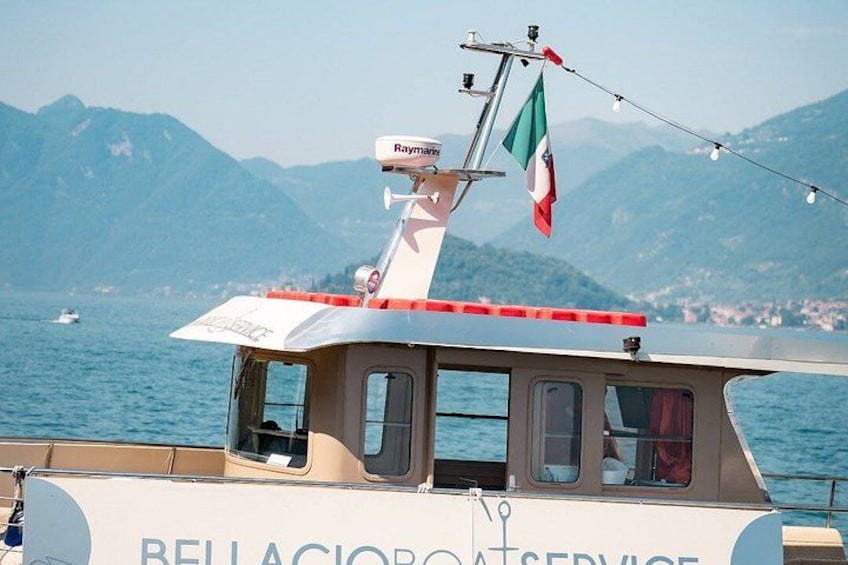 A boat with a cabin, a mast with a flag, and a mountainous landscape in the background. 3