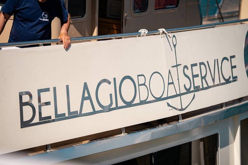 A boat with a sign that reads 'BELLAGIOBOAT SERVICE' and an anchor symbol. 2